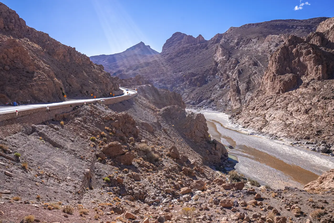 Winding mountain road with river in the High Atlas
