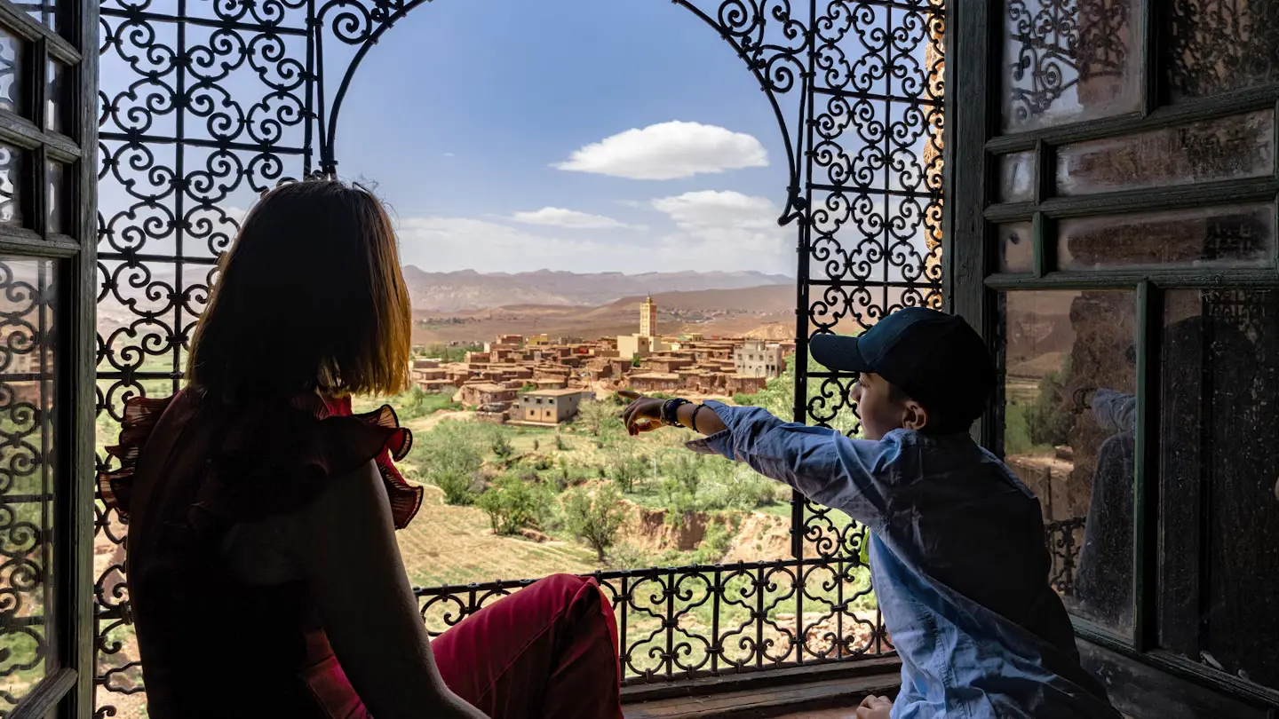 Mother and son overlooking a kasbah village — Morocco family tour with kids