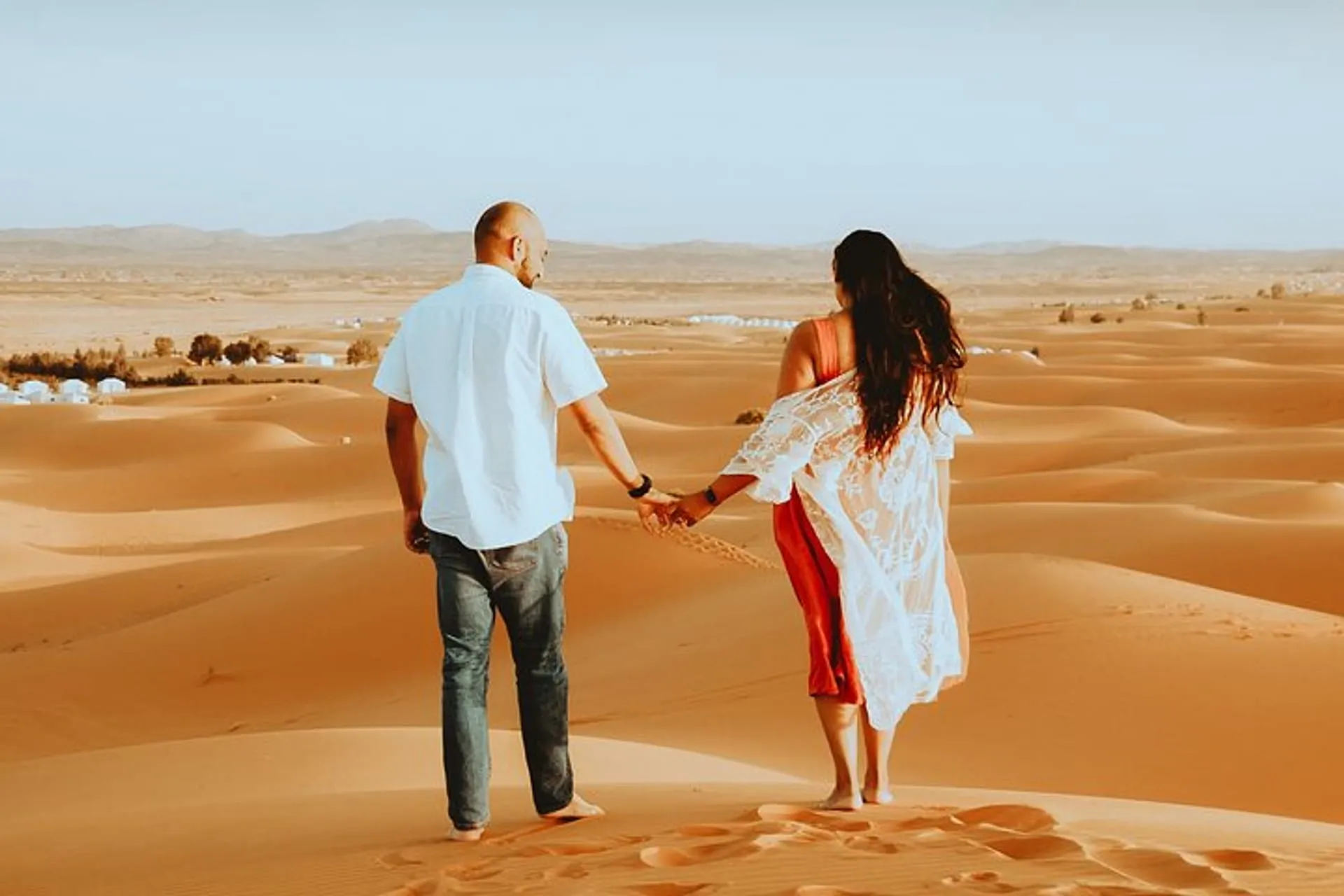 Couple at sunset on the Merzouga dunes — two nights under Sahara stars